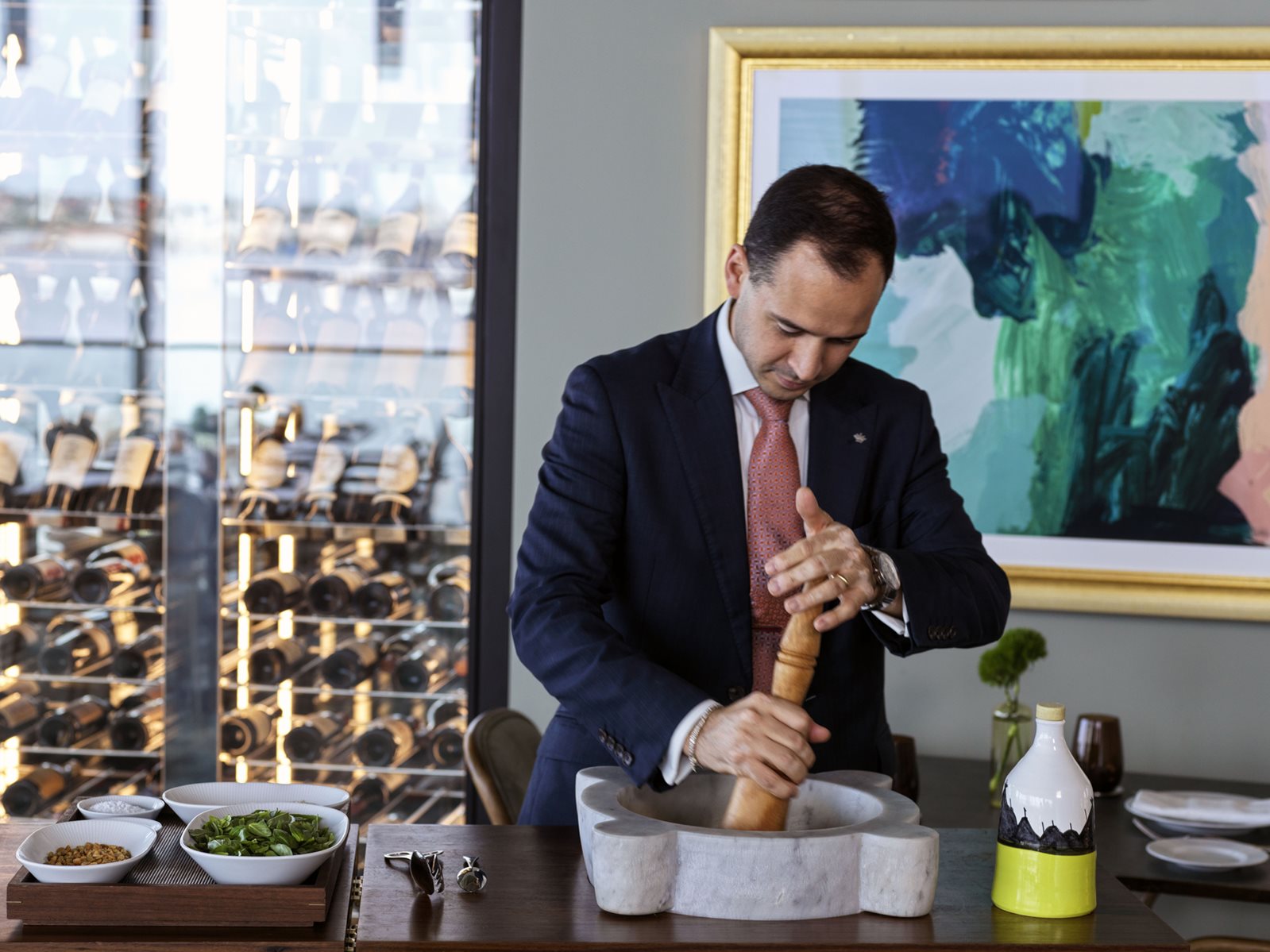 A'Mare chef preparing dish and holding large pepper grinder
